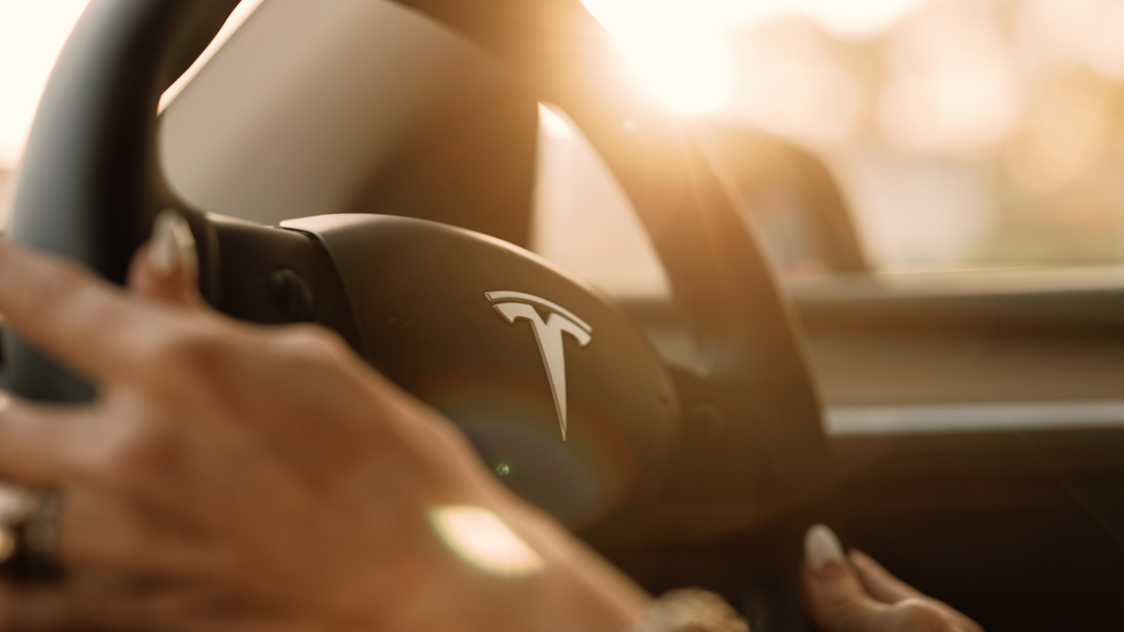 Professional driver at the wheel of a fully electric vehicle on a Noosa airport transfer